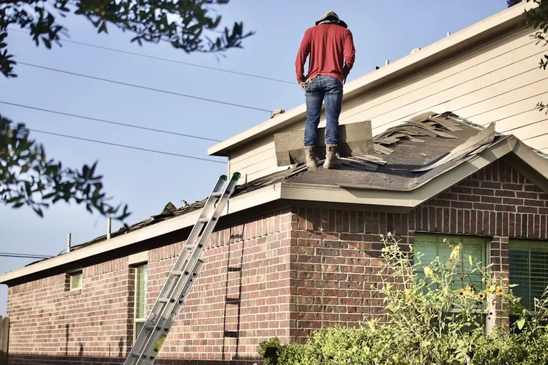 Professional roofer working on a residential roof in Over-The Rhine